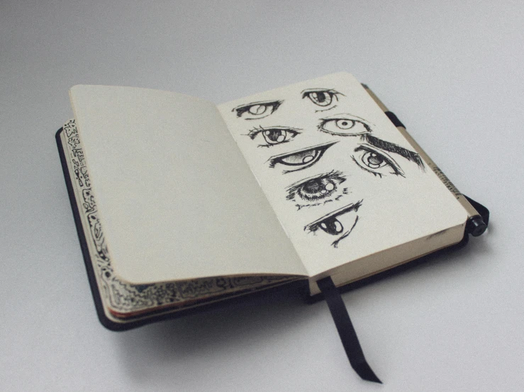 a close up of an open book with drawings