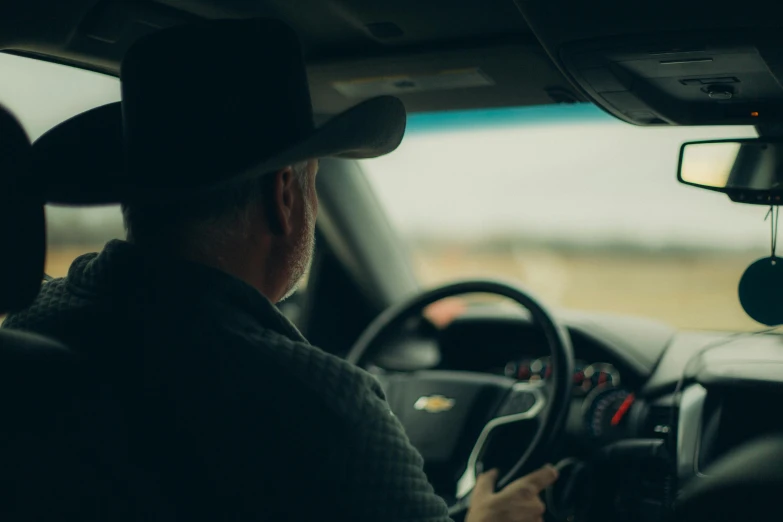 a man driving his car on the road