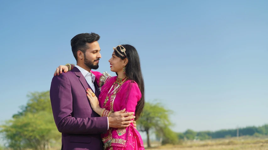 a man and woman emcing each other in the desert