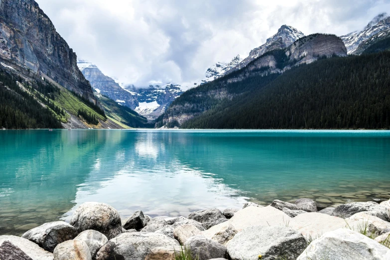 some rocks a body of water and a mountain