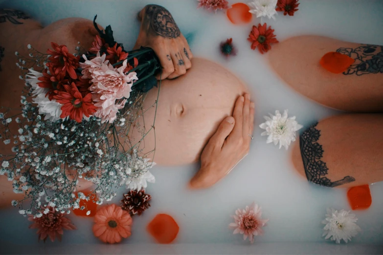 an image of a body in a bath with flowers and other things