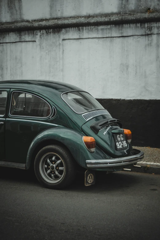 the volkswagen beetle sits parked in the parking lot