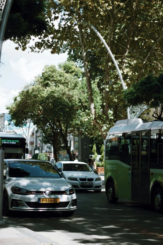 a bus passing by cars on a city street