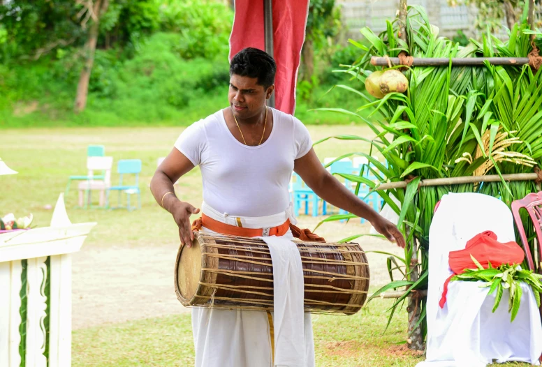 a man plays the djembe at a wedding