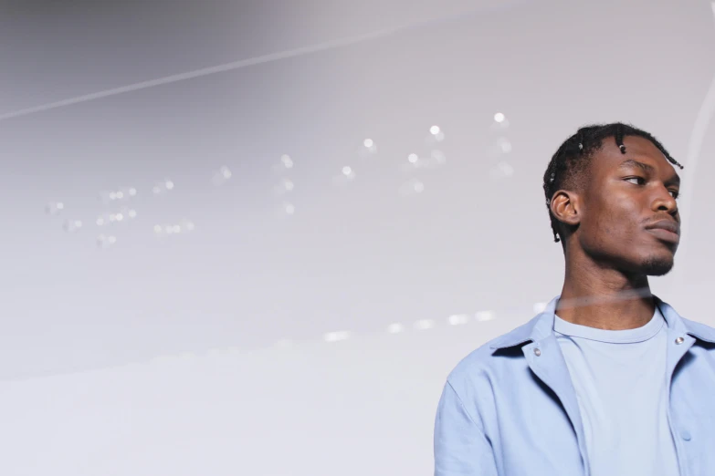 a male in a blue shirt is looking up