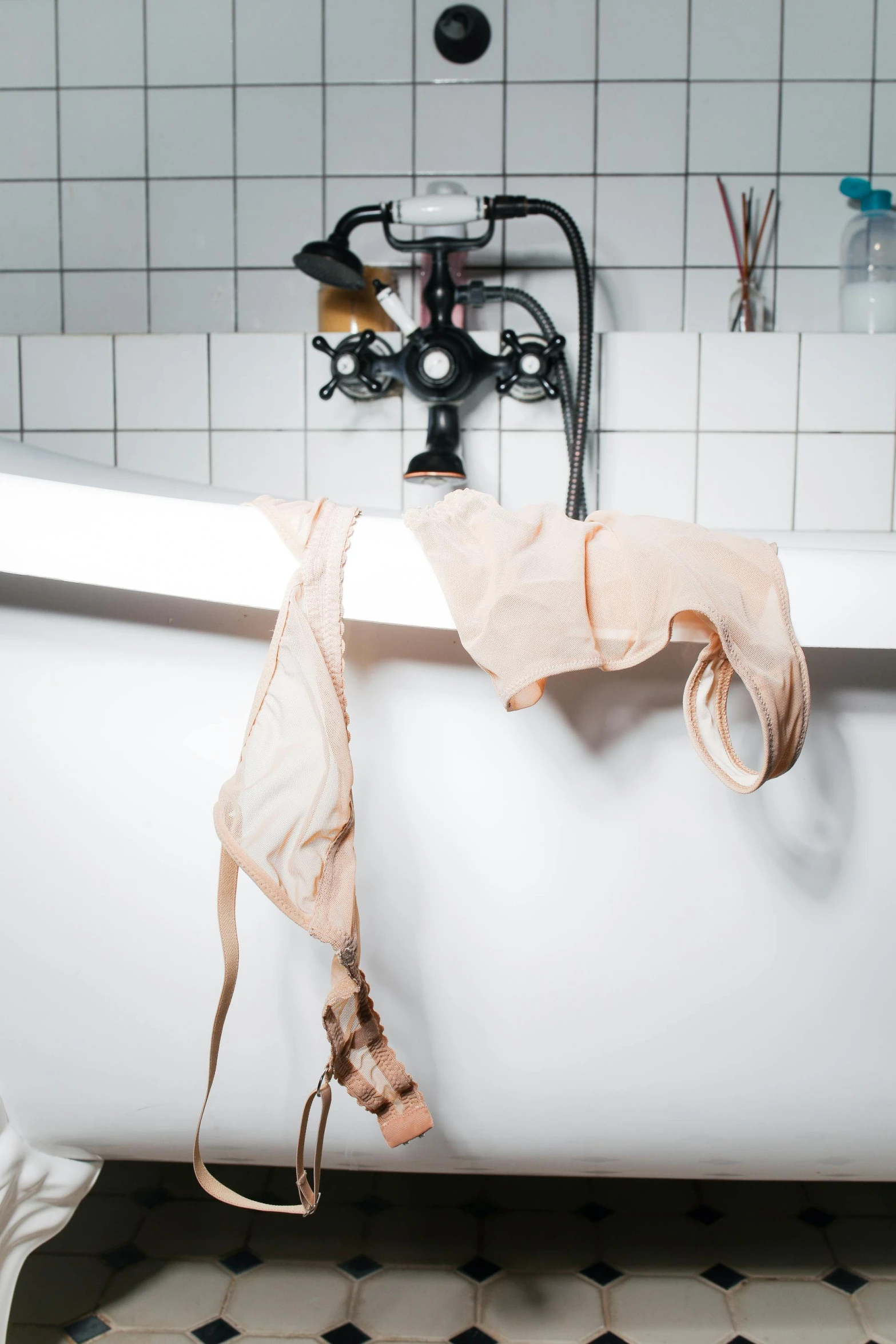 a very old white bathtub with tied up ties