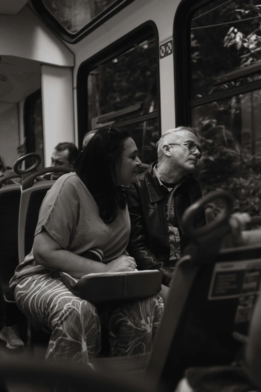 a man and woman are riding the train