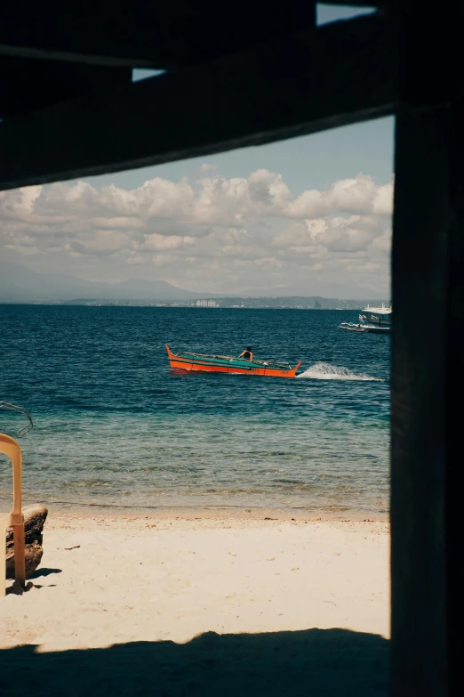 a beach area with two boats on the water