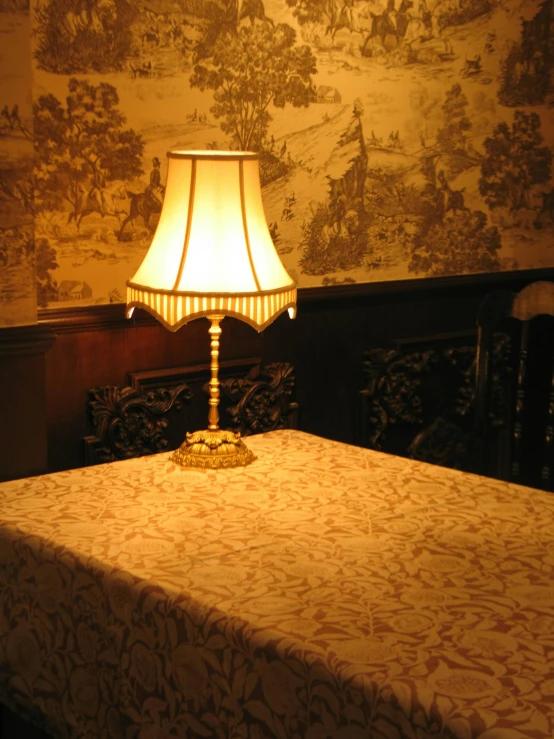 a white lamp on a table under a lampshade