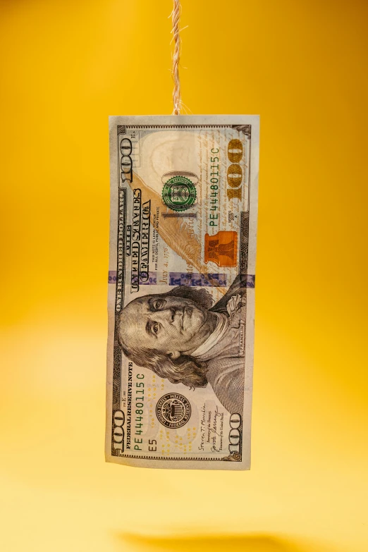 a five dollar bill hanging from a rope