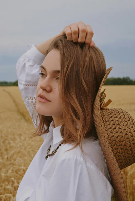 a woman with long hair is standing in a field