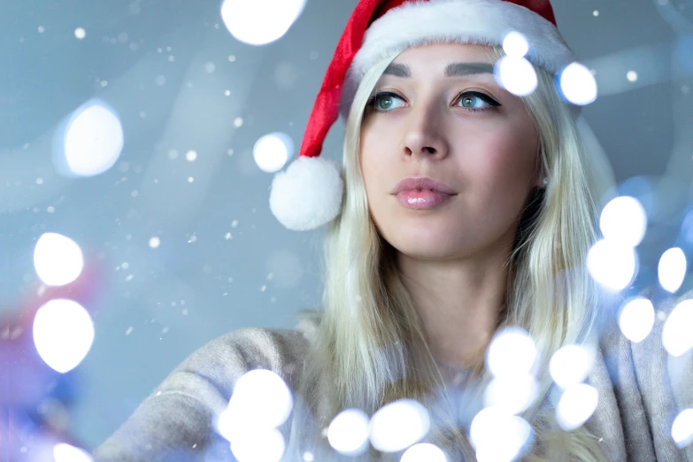 a beautiful woman with a santa hat on