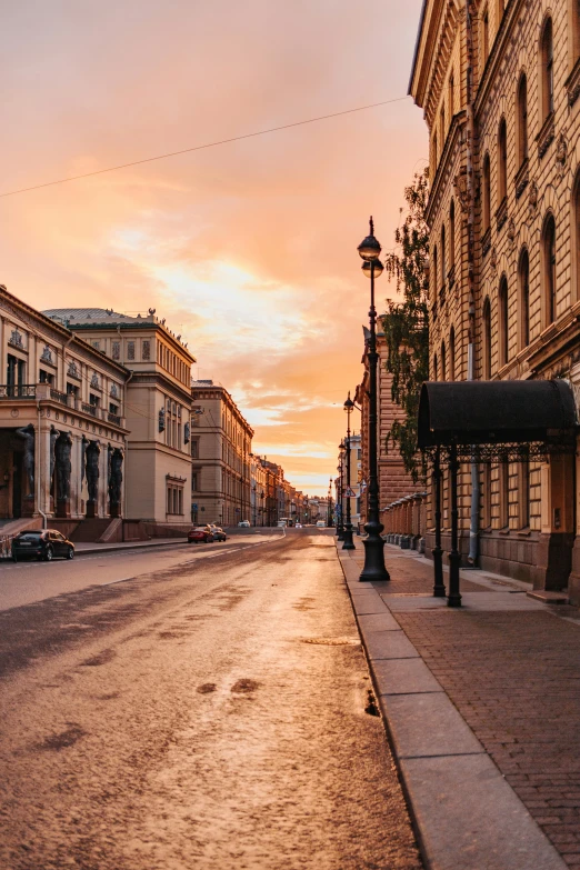 a small street lined with tall building next to a street light