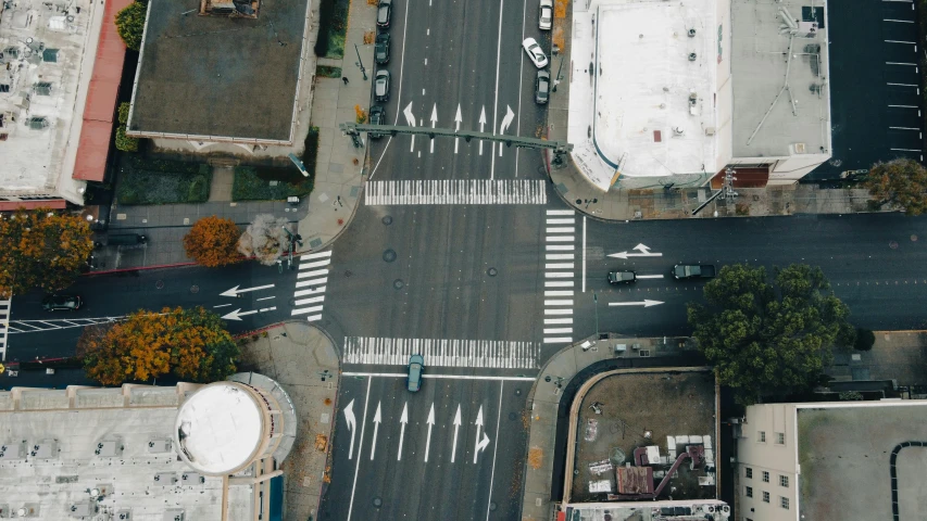 an aerial view of a street intersection in front of some houses