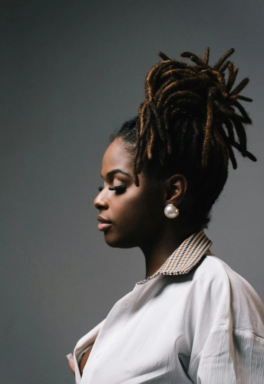 an african american woman with dreadlocks stares at the camera