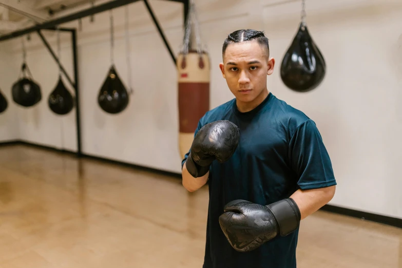 a man holding a pair of boxing gloves