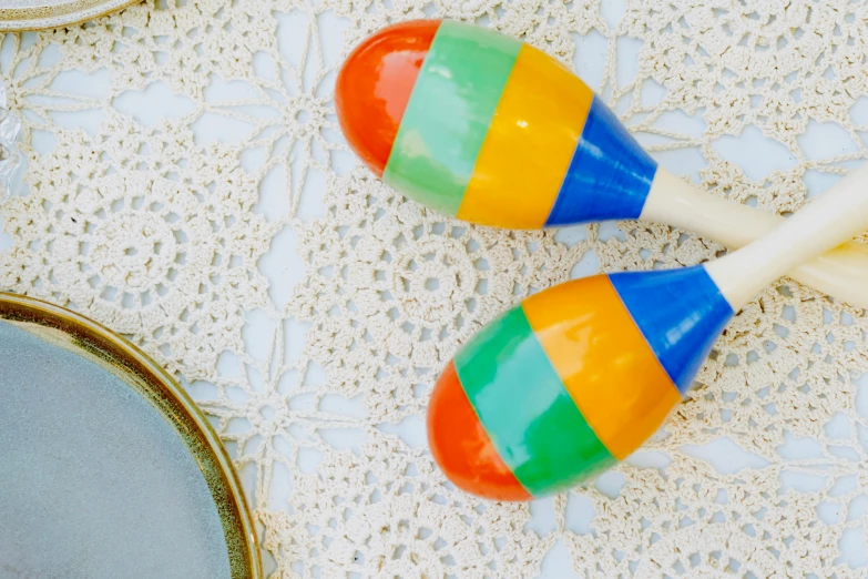 two colorful wooden rattlers sitting next to a mirror