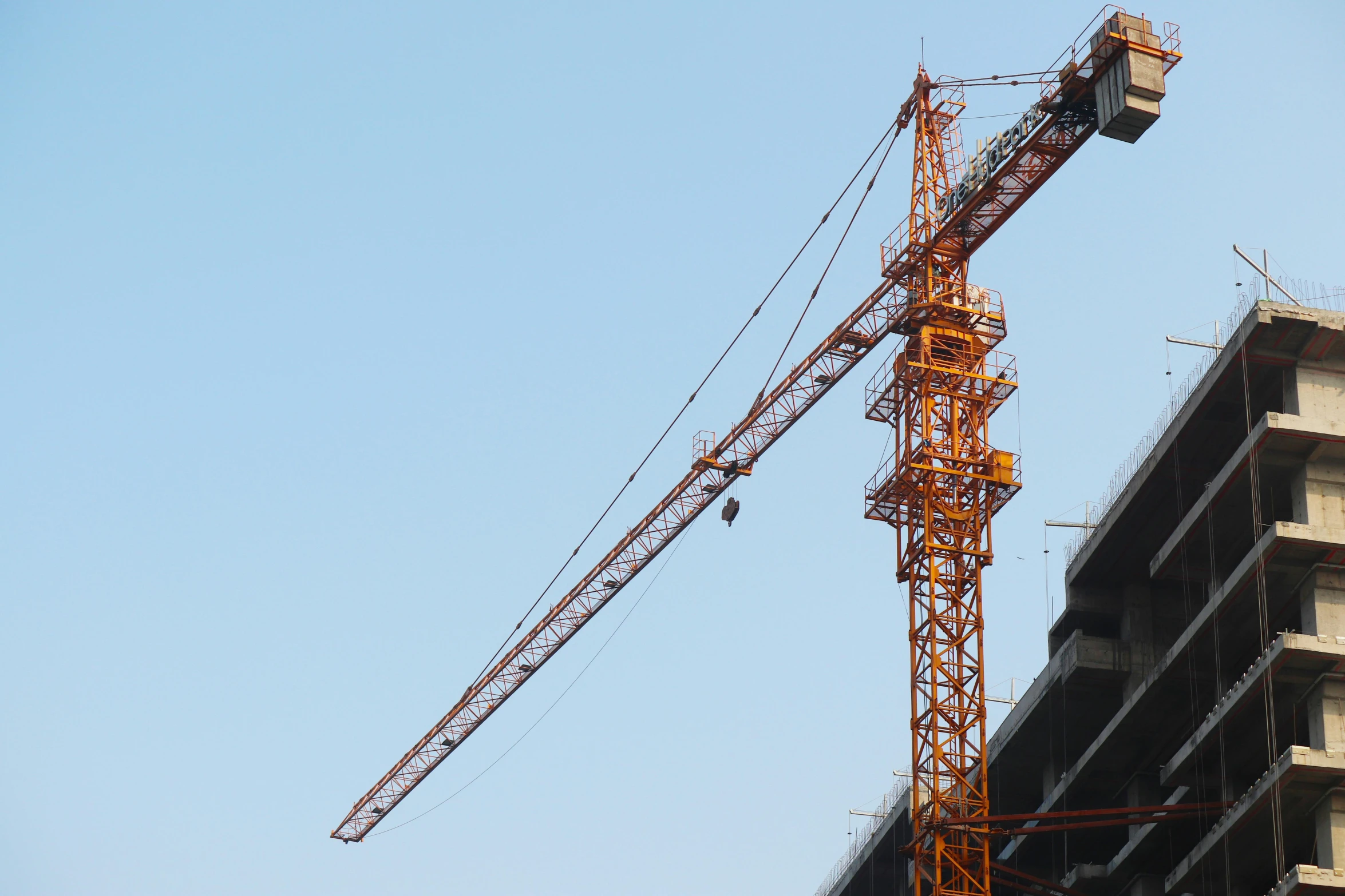 the crane has been lowered by a large construction crane