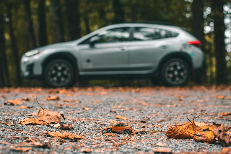 a sports car parked in front of some trees