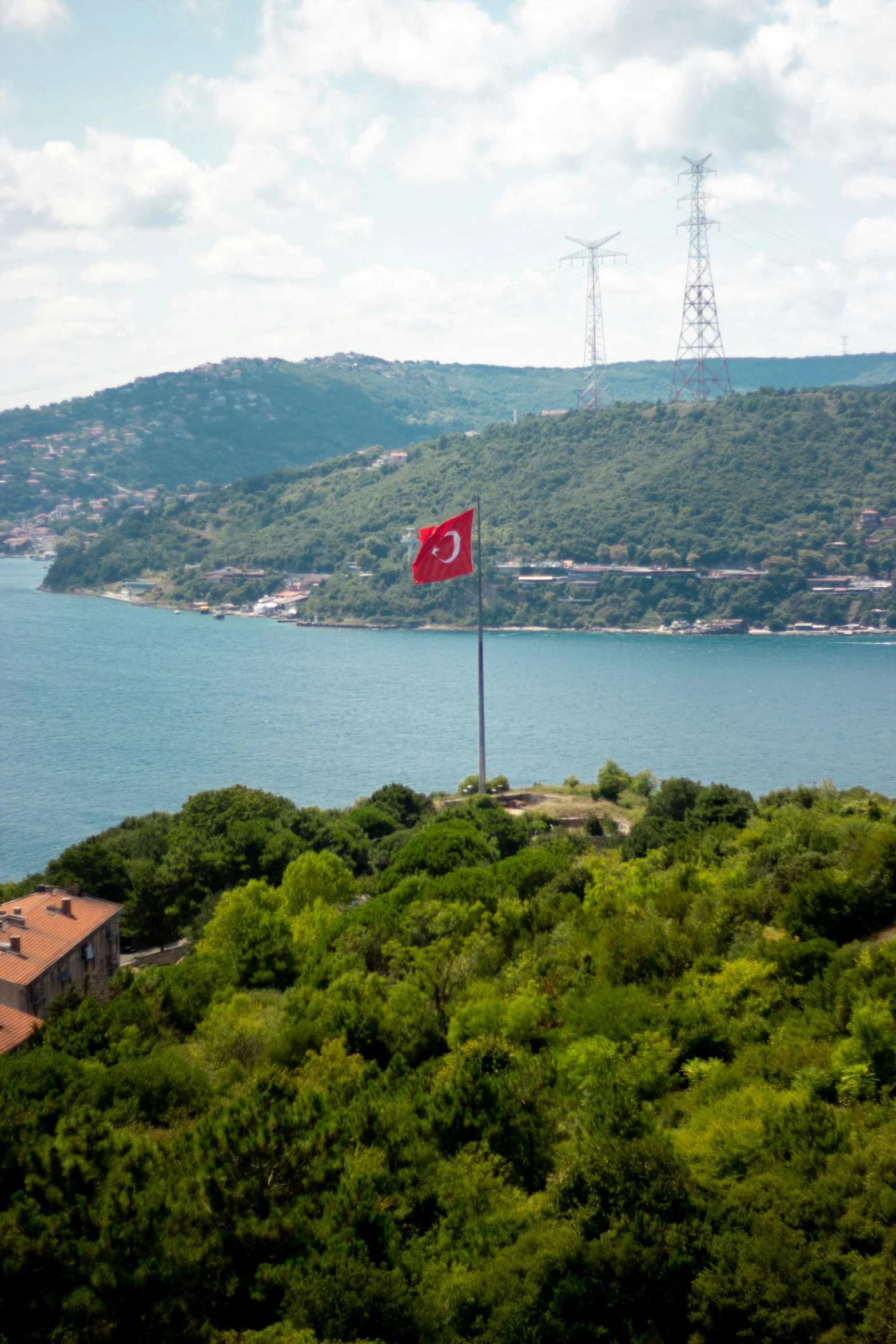 an empty flag on a tall pole sitting in the middle of a field