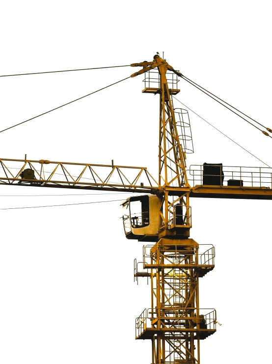 a yellow tower with a crane inside and electrical wires above