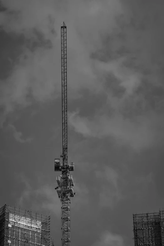 a very tall tower standing in the middle of a cloudy sky