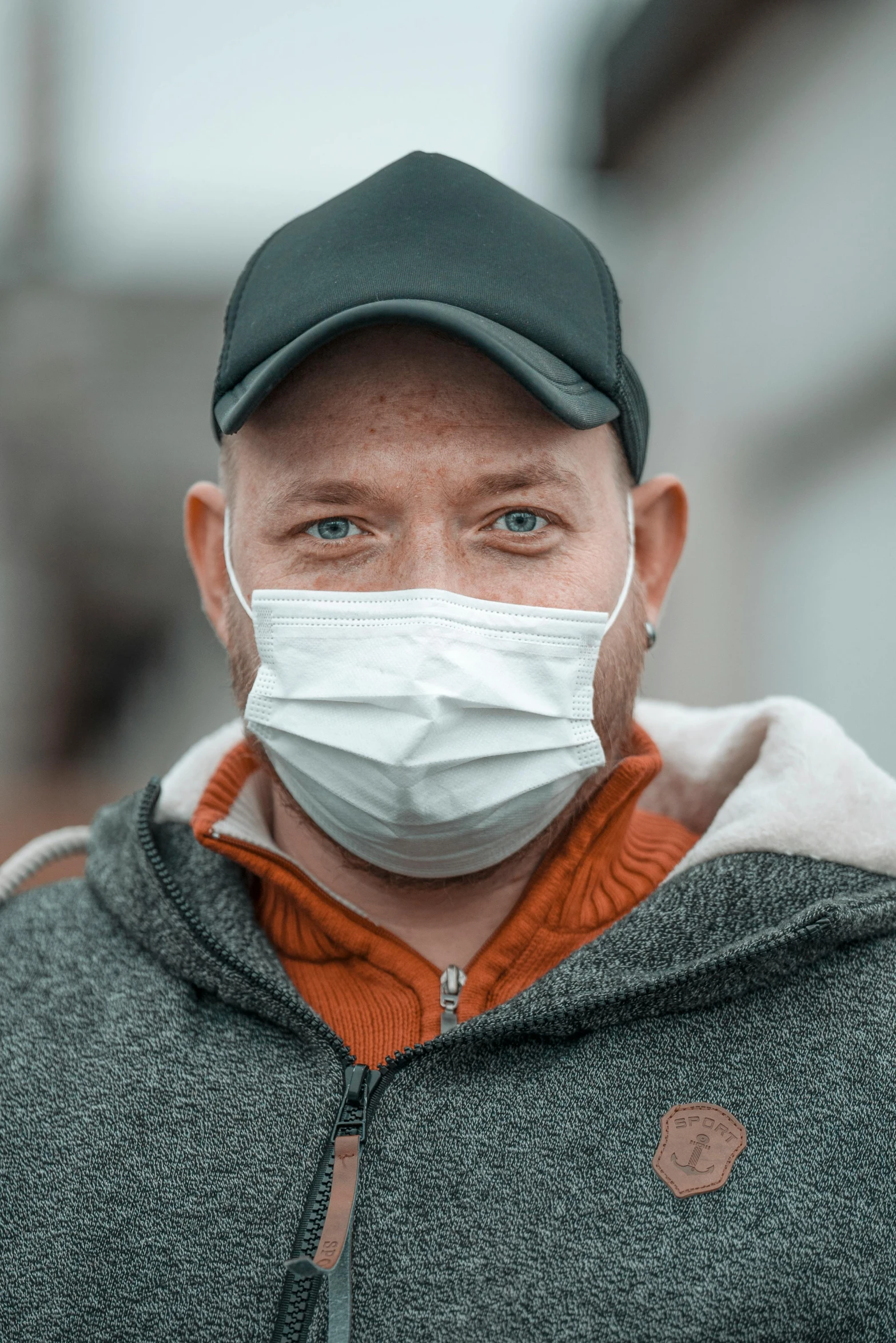 a man with a medical mask on, covering his face