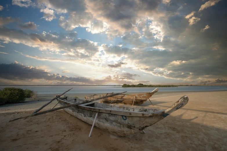 a sandy beach with a boat in the distance