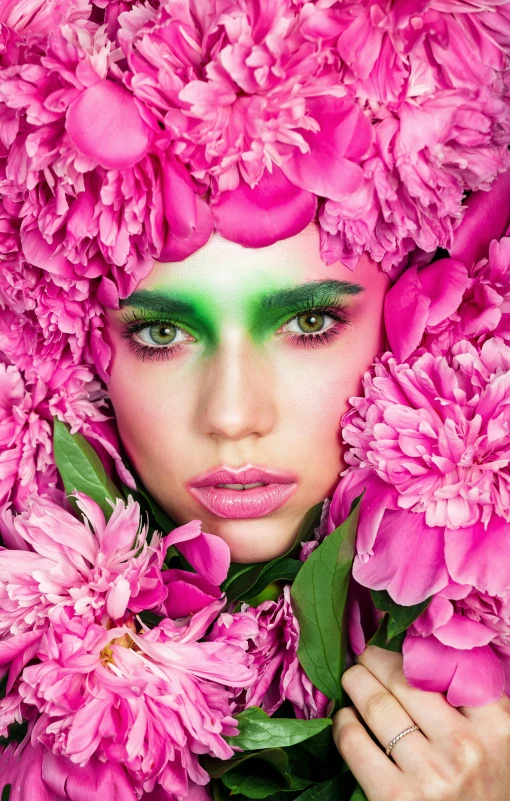 a beautiful young woman with green eyes and pink flowers