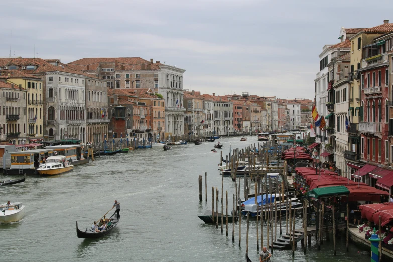 a river with many boats and houses along side