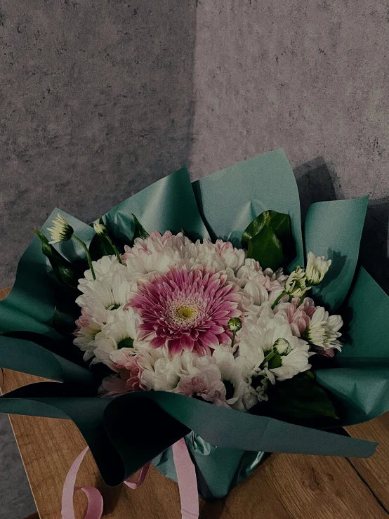 a bouquet of flowers sit on a wooden box