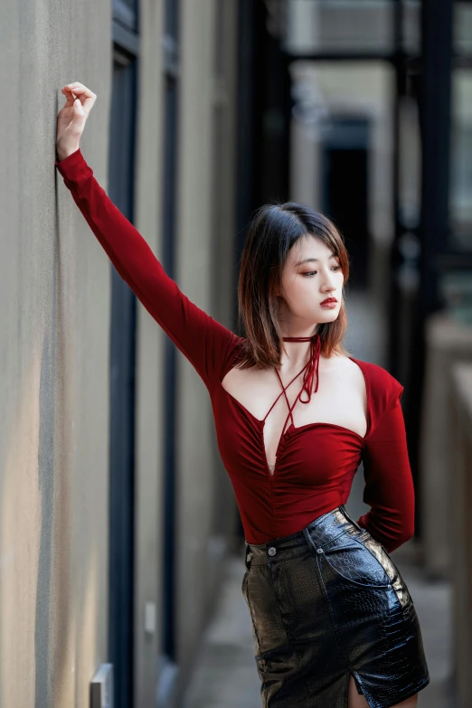 woman with arms wide open looking at wall