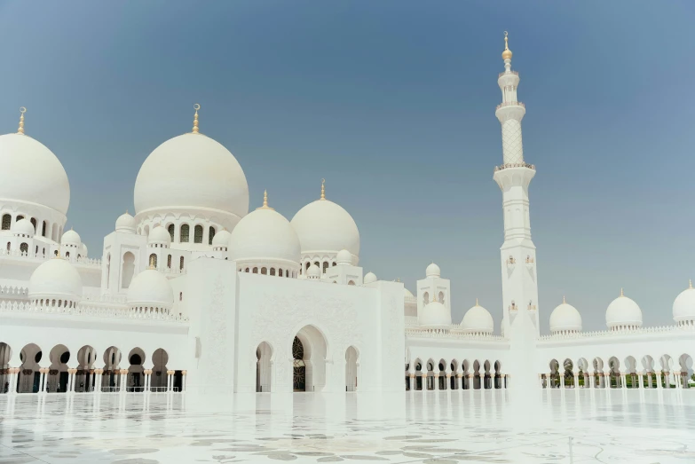 a large white building with multiple domes and pillars