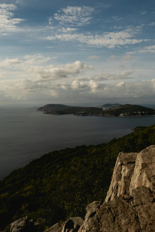 a body of water next to a rocky hillside