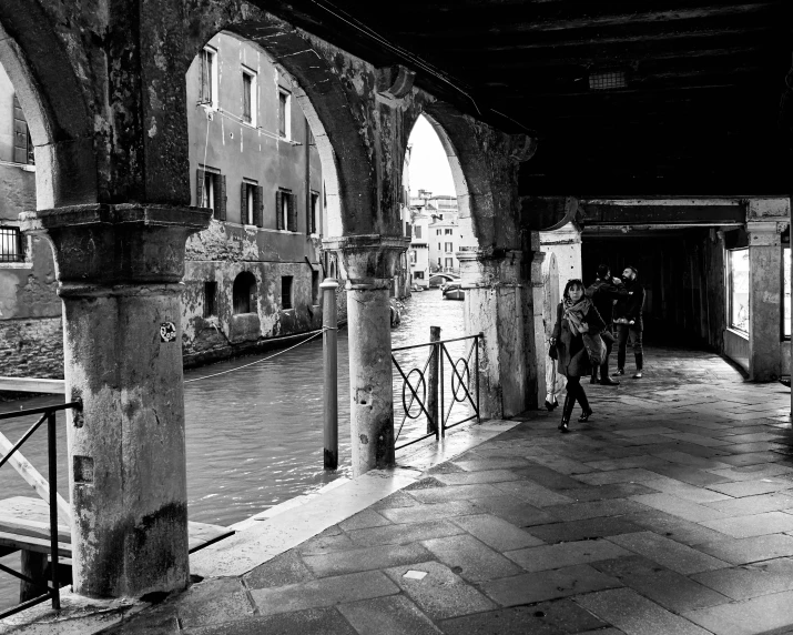 two people ride bicycles in an old building