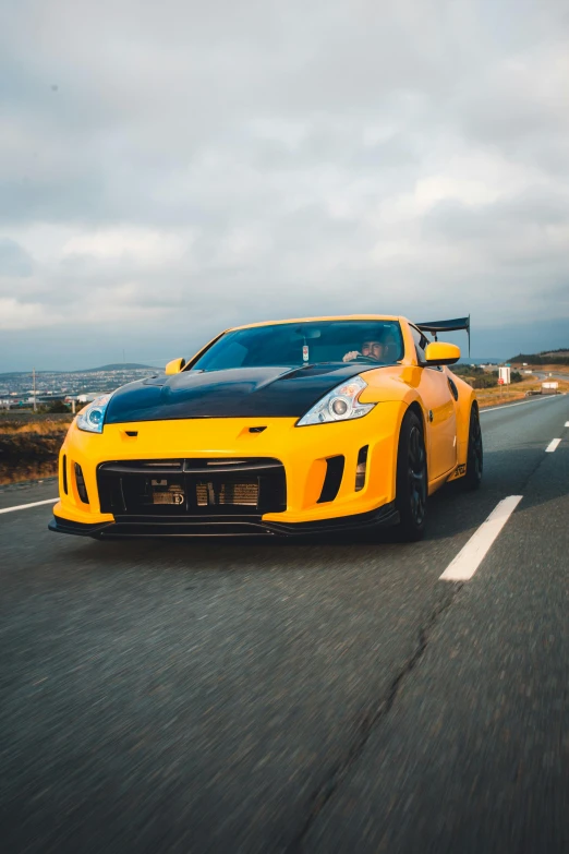 yellow sports car sitting in the middle of the road