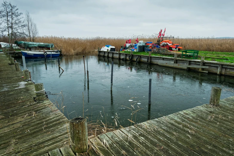 a dock on a river is filled with boats