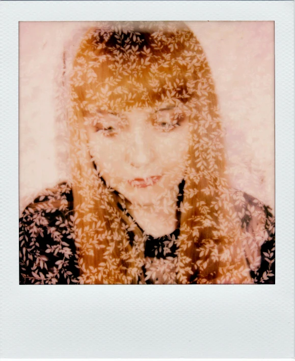 a lady with her face close to the camera and covered in white feathers