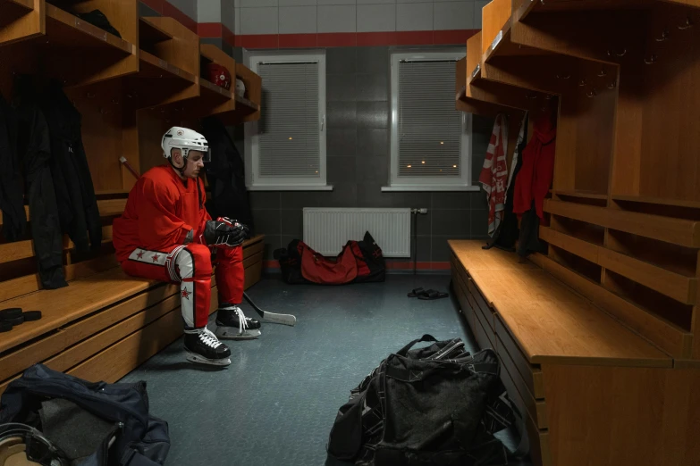 a person in a locker room with a hockey helmet on