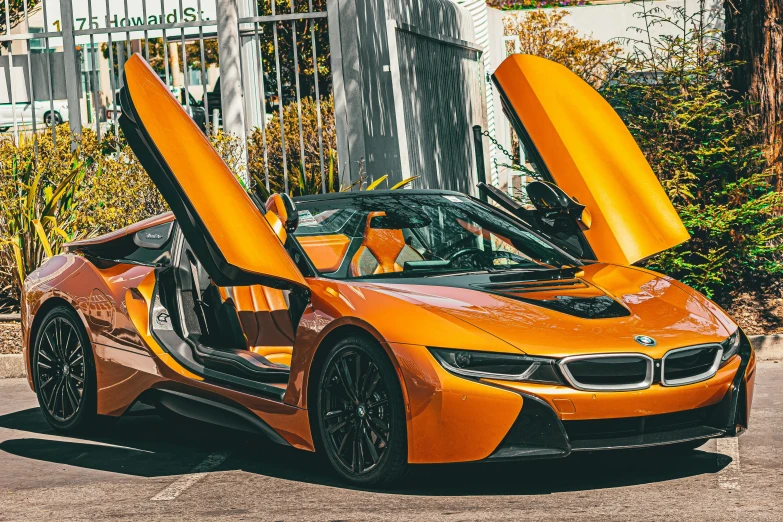 the open door on an orange bmw sports car