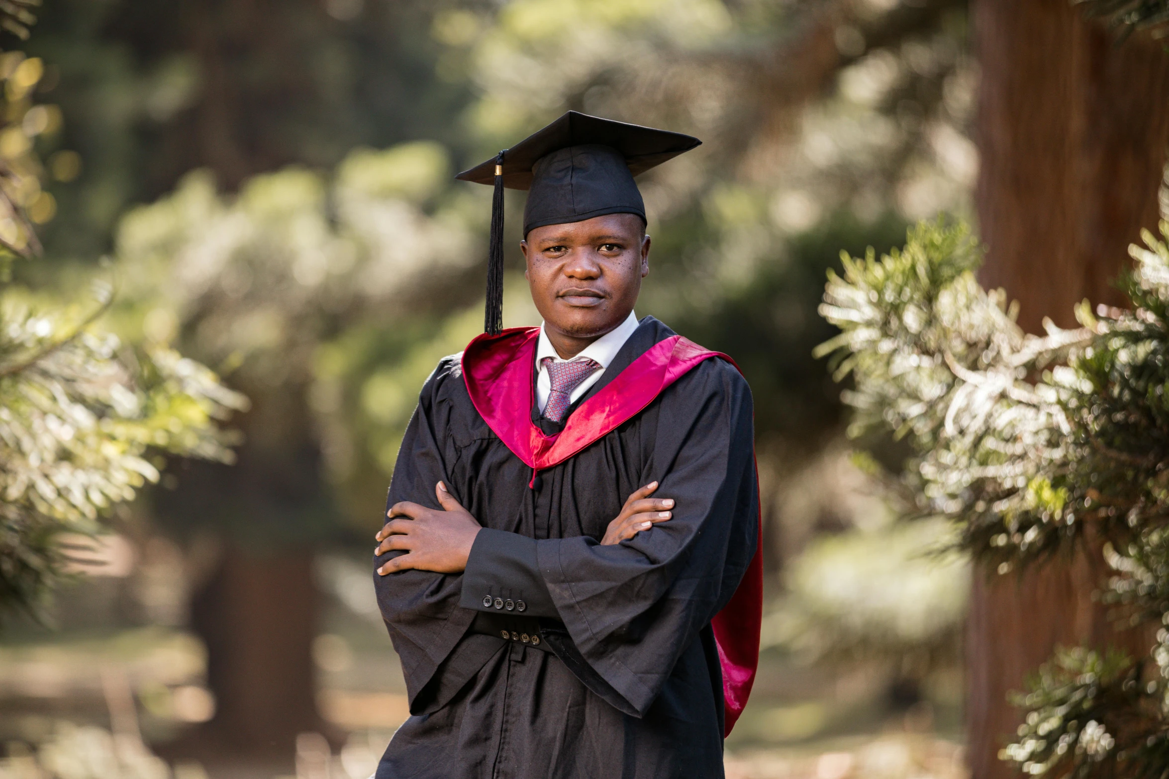 an older black man wearing a cap and gown