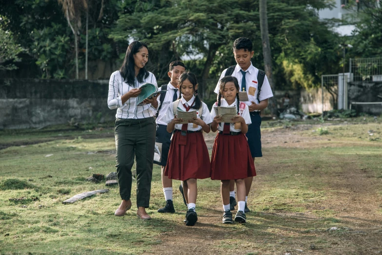 group of s dressed in school uniforms outside