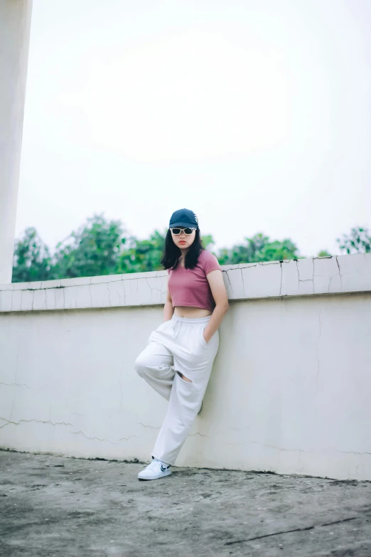 woman leaning against a wall with her head up