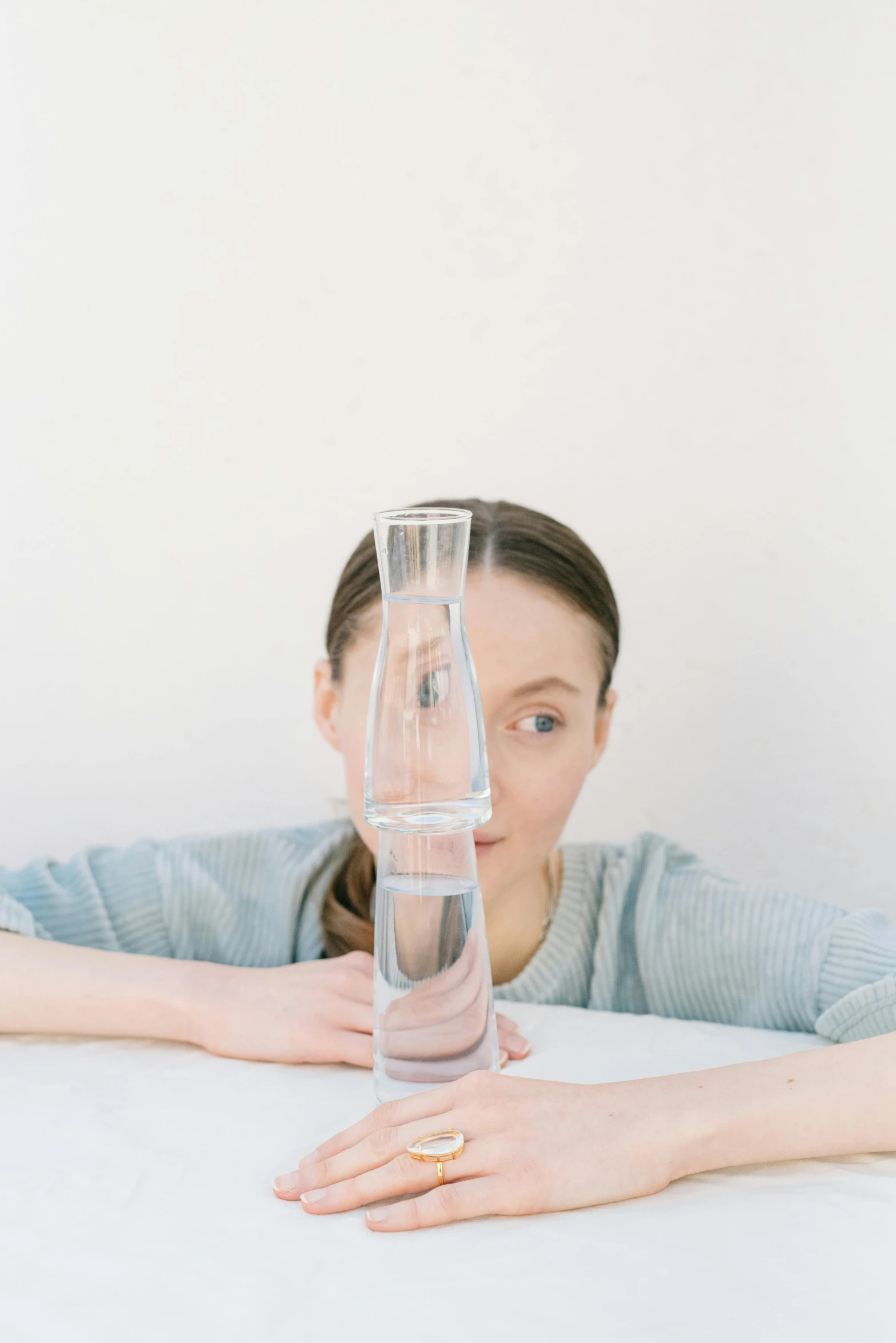 a woman leaning on a table in front of an object