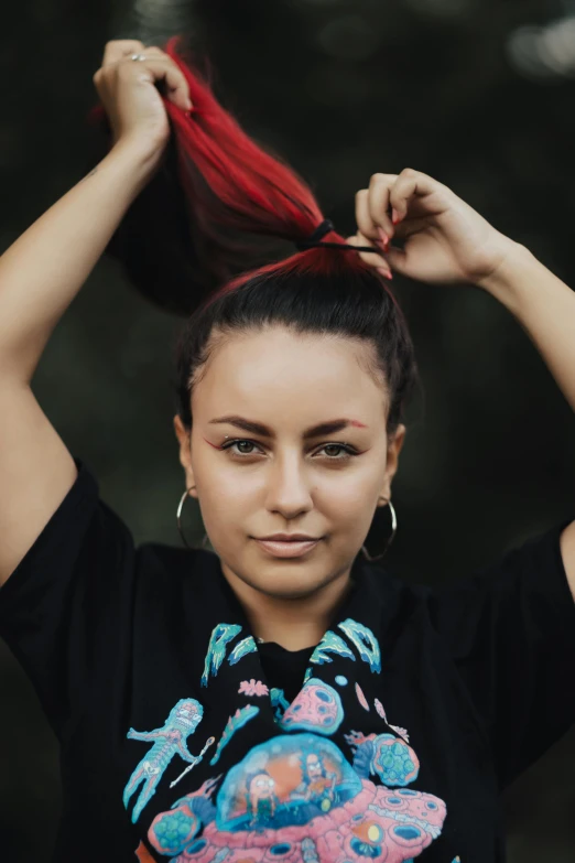 a woman with pigtails is putting her hair down