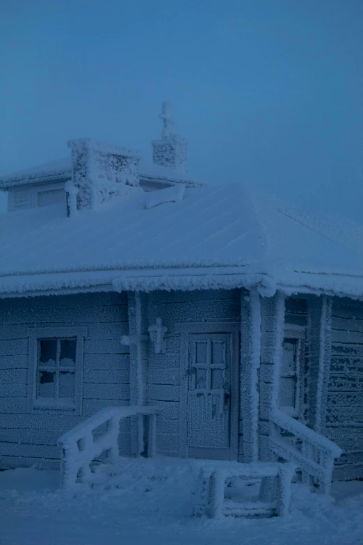 a small white building covered in snow