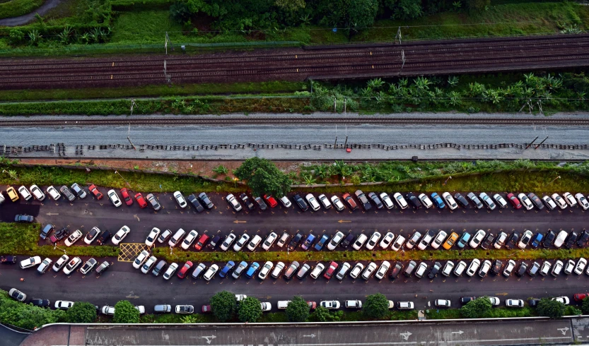 an overhead s of a parking lot filled with cars