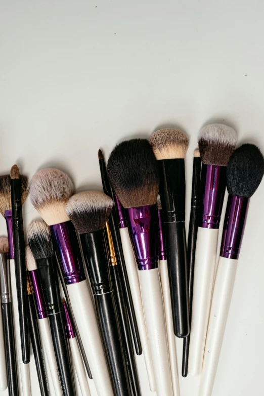 an assortment of makeup brushes laid out in a circle