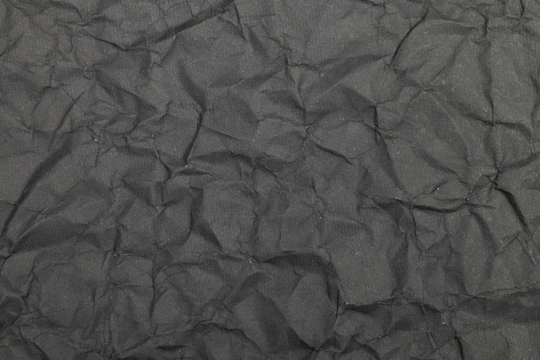 black sand covered in thin bits of dirt