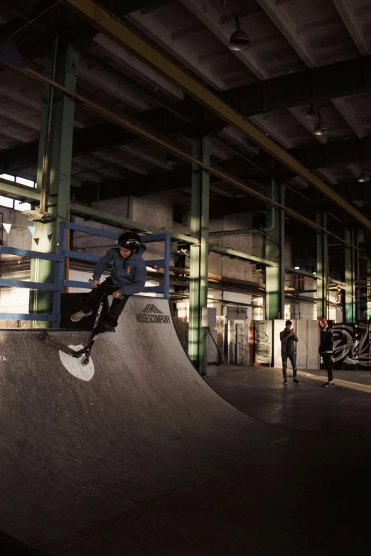 a skateboarder performs a stunt in an indoor skate park